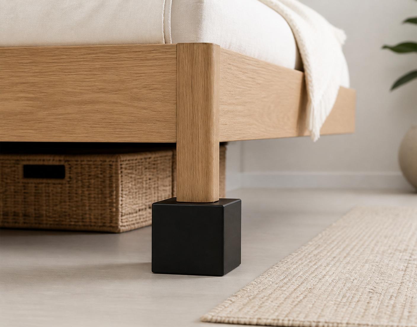 A custom furniture riser seated under a wooden furniture leg